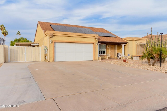 view of front of property featuring a garage and solar panels