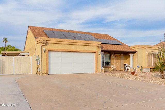 view of front facade featuring a garage and solar panels