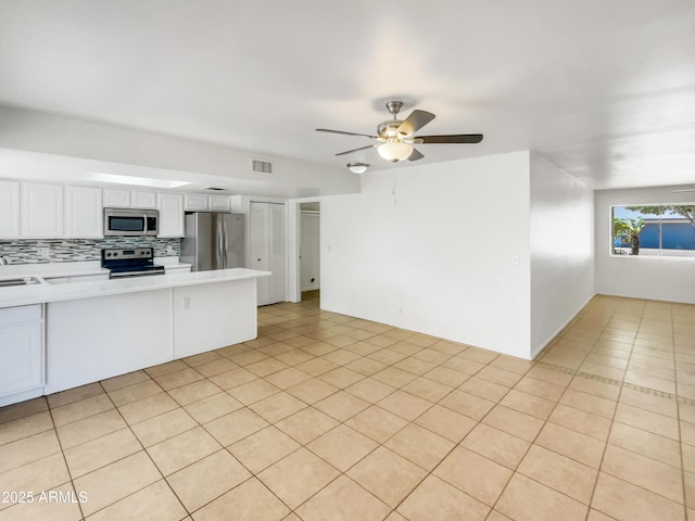 920 E Garnet Ave, Mesa, AZ 85204 - kitchen featuring stainless steel appliances, light countertops, white cabinetry, decorative backsplash, and a peninsula