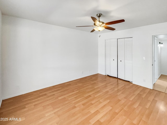 920 E Garnet Ave, Mesa, AZ 85204 - unfurnished bedroom with light wood finished floors, a closet, a ceiling fan, and baseboards