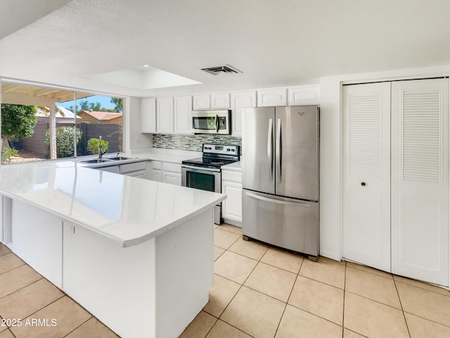 920 E Garnet Ave, Mesa, AZ 85204 - kitchen with appliances with stainless steel finishes, a sink, light countertops, and light tile patterned floors