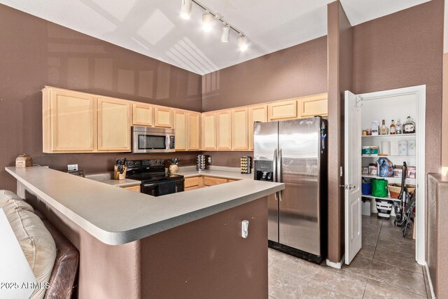 1350 S Greenfield Rd Unit 2205, Mesa, AZ 85206 - kitchen featuring appliances with stainless steel finishes, light brown cabinets, rail lighting, light tile patterned flooring, and a towering ceiling