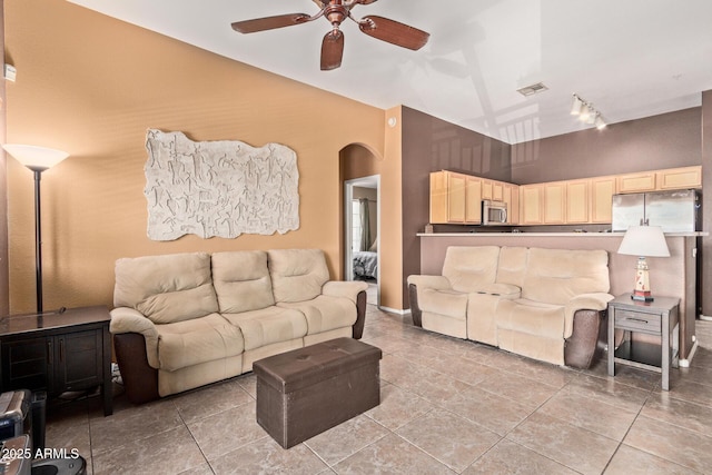 1350 S Greenfield Rd Unit 2205, Mesa, AZ 85206 - living room featuring rail lighting, a ceiling fan, arched walkways, and light tile patterned floors