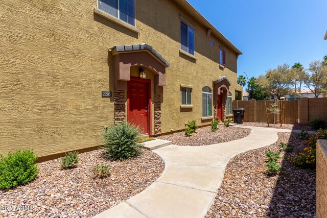 1350 S Greenfield Rd Unit 2205, Mesa, AZ 85206 - view of exterior entry with fence and stucco siding