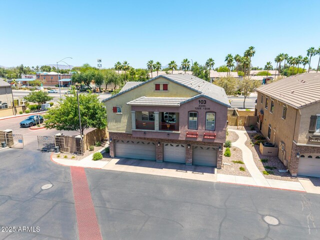 1350 S Greenfield Rd Unit 2205, Mesa, AZ 85206 - multi unit property with an attached garage, asphalt driveway, stucco siding, and fence