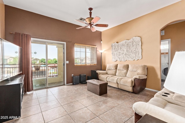 1350 S Greenfield Rd Unit 2205, Mesa, AZ 85206 - living room with arched walkways, ceiling fan, light tile patterned floors, and baseboards