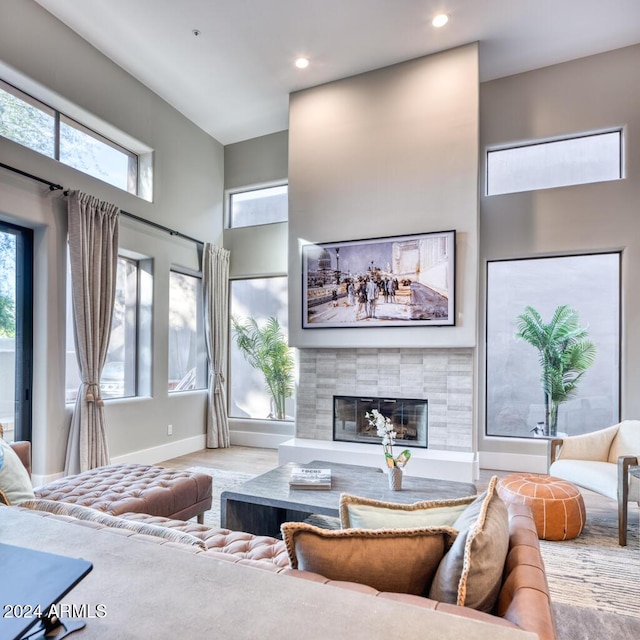 living room featuring a high ceiling and a tile fireplace