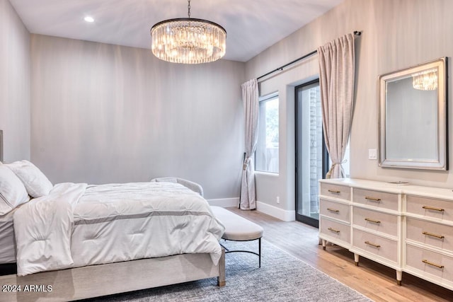 bedroom featuring a chandelier and light hardwood / wood-style floors