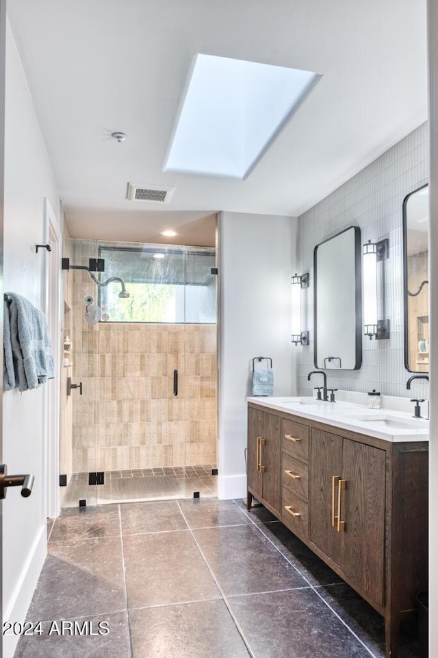 bathroom featuring vanity, a shower with door, and tile walls