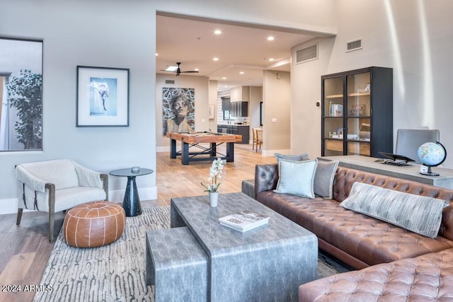 living room with ceiling fan and hardwood / wood-style flooring