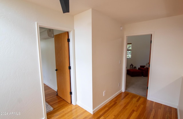 5120 N Juniper Loop, Pine, AZ 85544 - hall with a wall mounted air conditioner, baseboards, and light wood-type flooring