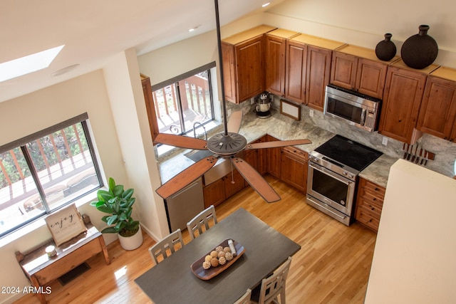 5120 N Juniper Loop, Pine, AZ 85544 - kitchen with a wealth of natural light, light wood-type flooring, stainless steel appliances, and a skylight