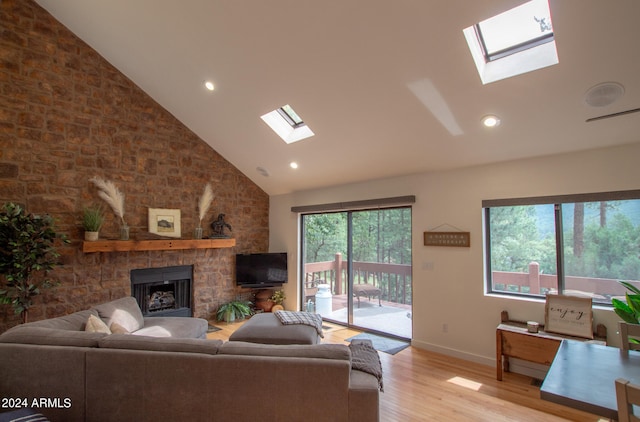 5120 N Juniper Loop, Pine, AZ 85544 - living room with wood finished floors, a skylight, a stone fireplace, and high vaulted ceiling