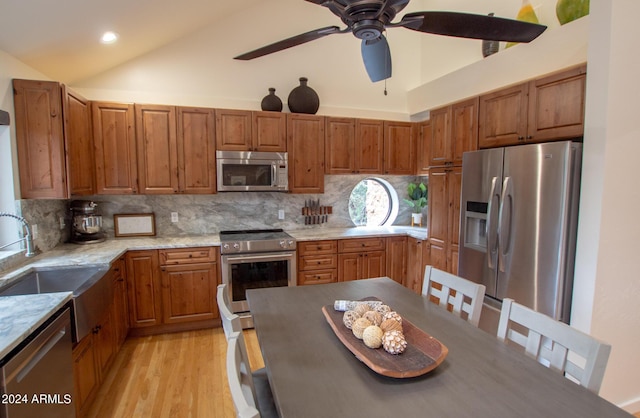 5120 N Juniper Loop, Pine, AZ 85544 - kitchen with light wood finished floors, a sink, brown cabinetry, backsplash, and appliances with stainless steel finishes