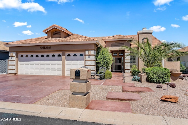 mediterranean / spanish-style house with a garage