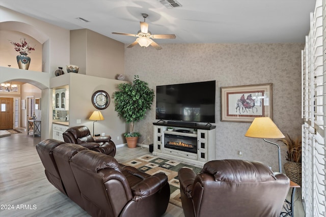 living room featuring light wood-type flooring and ceiling fan