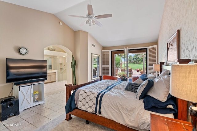 bedroom with light tile patterned flooring, ensuite bath, access to exterior, ceiling fan, and high vaulted ceiling