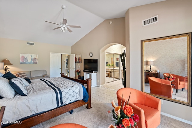 bedroom with ceiling fan, light carpet, and high vaulted ceiling