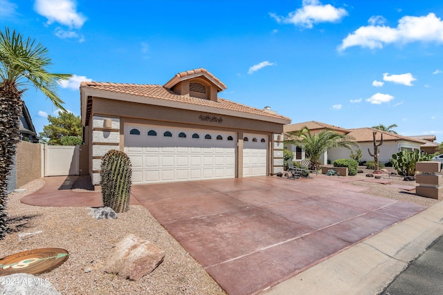 mediterranean / spanish home featuring a garage