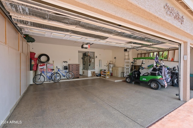 garage featuring a garage door opener and water heater