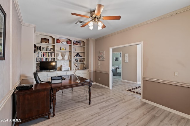 office with crown molding, built in shelves, light wood-type flooring, and ceiling fan