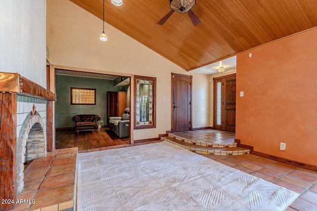 entryway with wooden ceiling, ceiling fan, tile patterned flooring, and high vaulted ceiling