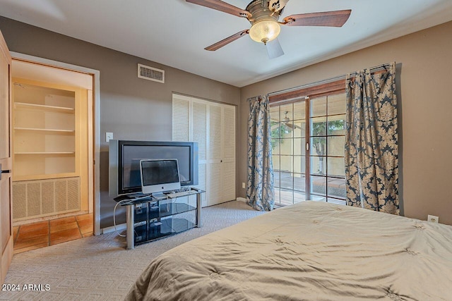 bedroom featuring light carpet, ceiling fan, and a closet