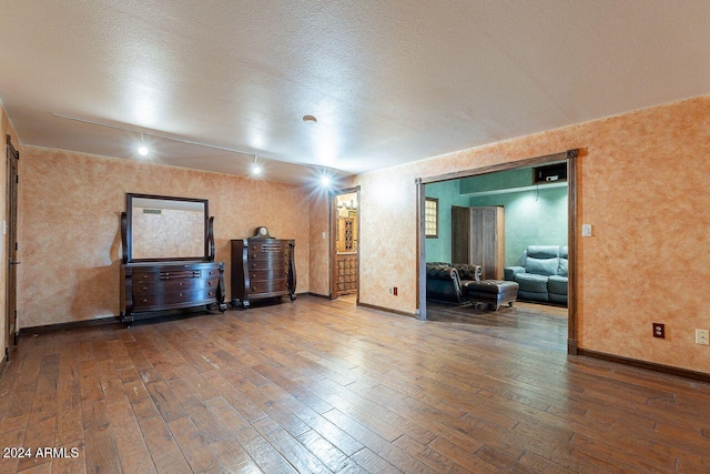 empty room featuring hardwood / wood-style floors and a textured ceiling