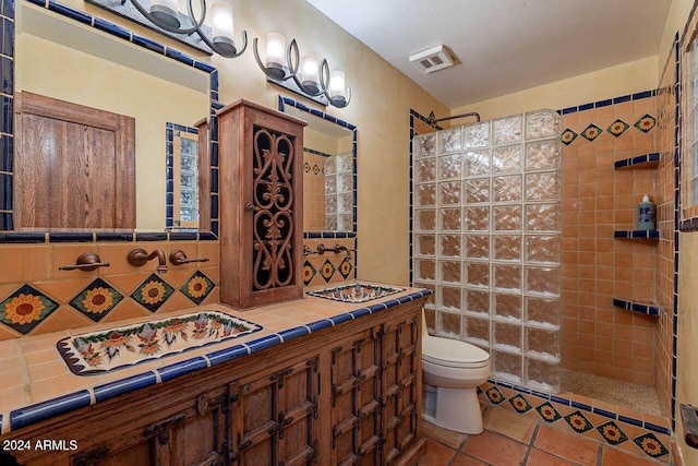 bathroom featuring tile walls, tiled shower, and toilet