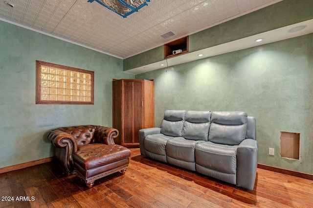 living room with wood-type flooring and crown molding