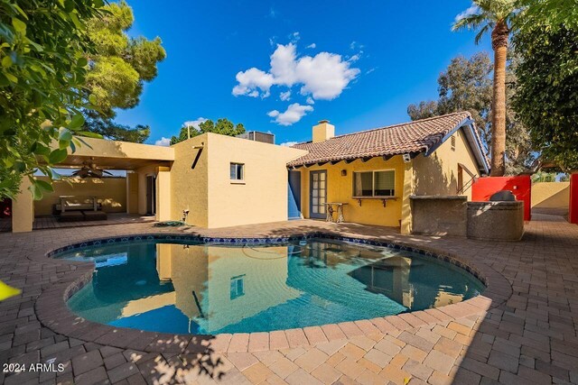 view of swimming pool with ceiling fan and a patio area