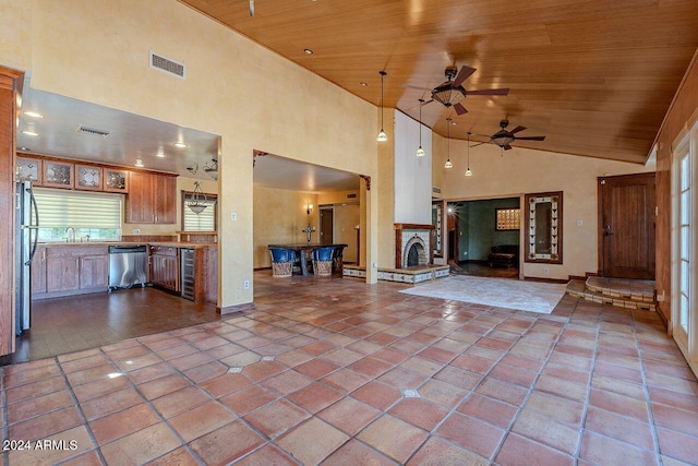 unfurnished living room featuring a fireplace, wine cooler, high vaulted ceiling, wooden ceiling, and ceiling fan