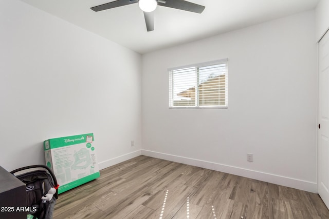 unfurnished bedroom with ceiling fan, baseboards, and wood finished floors