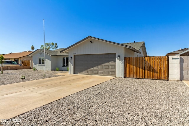 single story home with a gate, fence, an attached garage, and concrete driveway