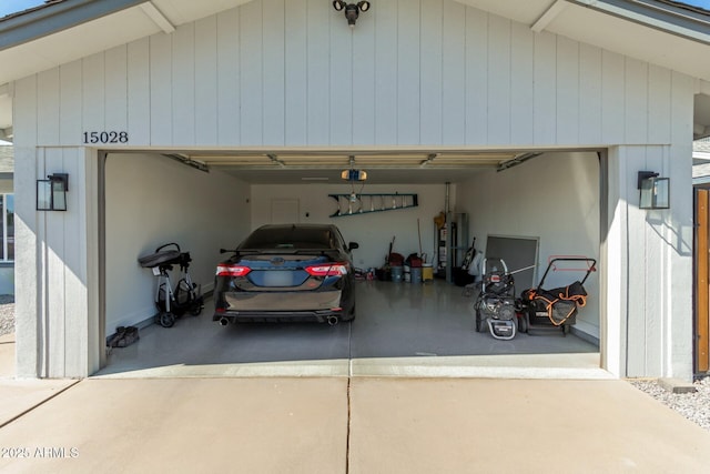 garage with driveway and gas water heater