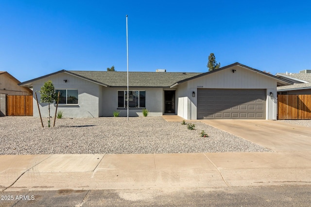 single story home featuring roof with shingles, stucco siding, concrete driveway, fence, and a garage