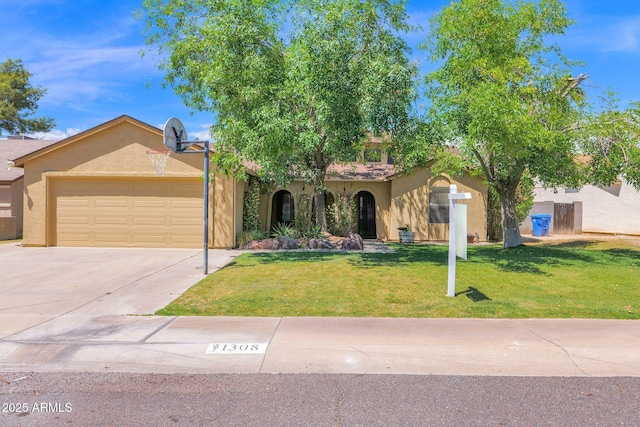 mediterranean / spanish-style home with an attached garage, driveway, a front lawn, and stucco siding