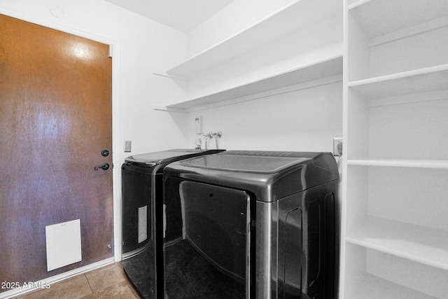 washroom featuring separate washer and dryer, tile patterned flooring, and laundry area