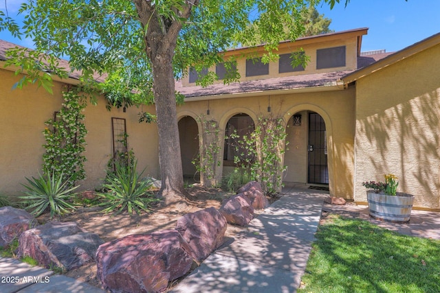 property entrance with stucco siding