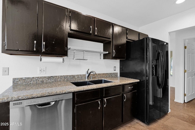 kitchen with stainless steel dishwasher, recessed lighting, light stone counters, a sink, and black fridge