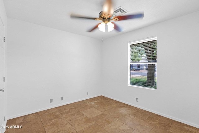 unfurnished room with baseboards, a ceiling fan, and visible vents