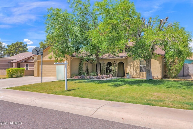 mediterranean / spanish-style home featuring concrete driveway, an attached garage, a front yard, and stucco siding