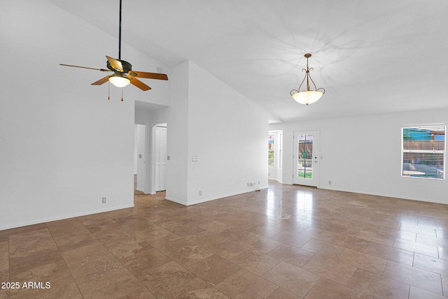 unfurnished living room with baseboards, ceiling fan, and high vaulted ceiling