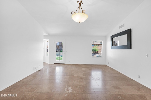 spare room with baseboards, visible vents, and plenty of natural light