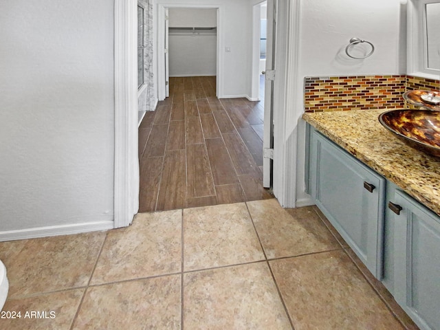 bathroom featuring tasteful backsplash, vanity, and hardwood / wood-style flooring