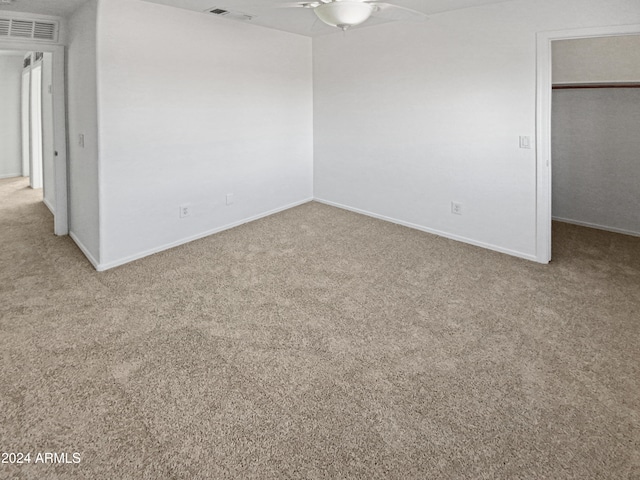 unfurnished bedroom with light carpet, a closet, and ceiling fan