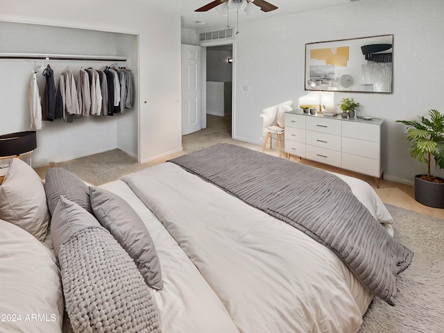 bedroom with ceiling fan, a closet, and light carpet