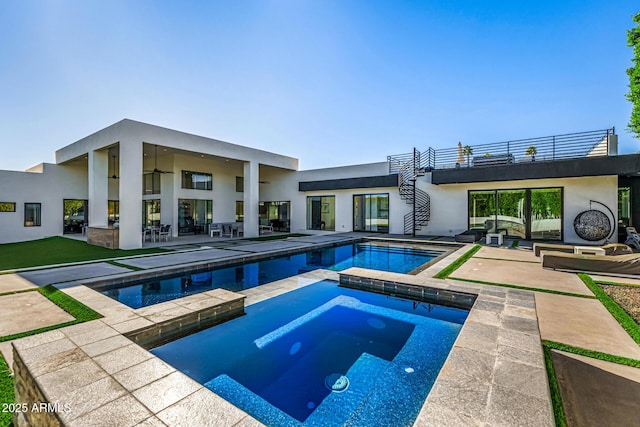 view of pool with a patio area and an in ground hot tub