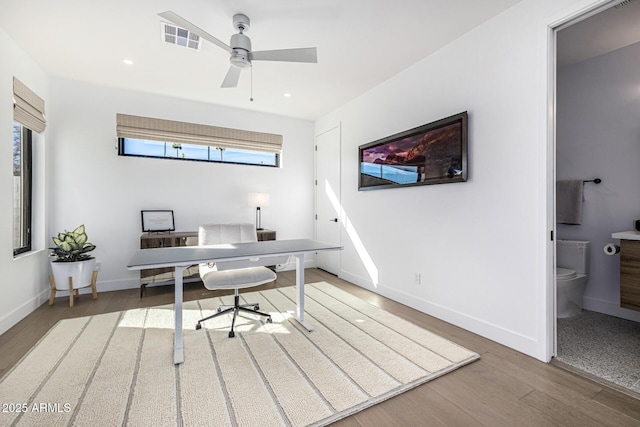 office space with ceiling fan and dark hardwood / wood-style flooring