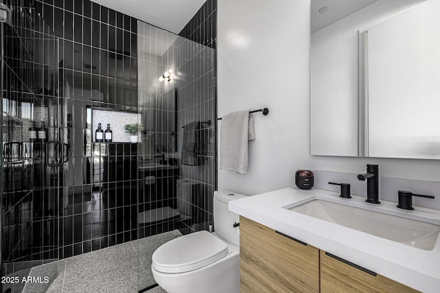 bathroom featuring walk in shower, vanity, and toilet